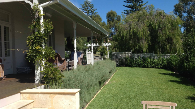 Finished Perth backyard by Landscapes For Life with paving, garden beds and lawn in full sun